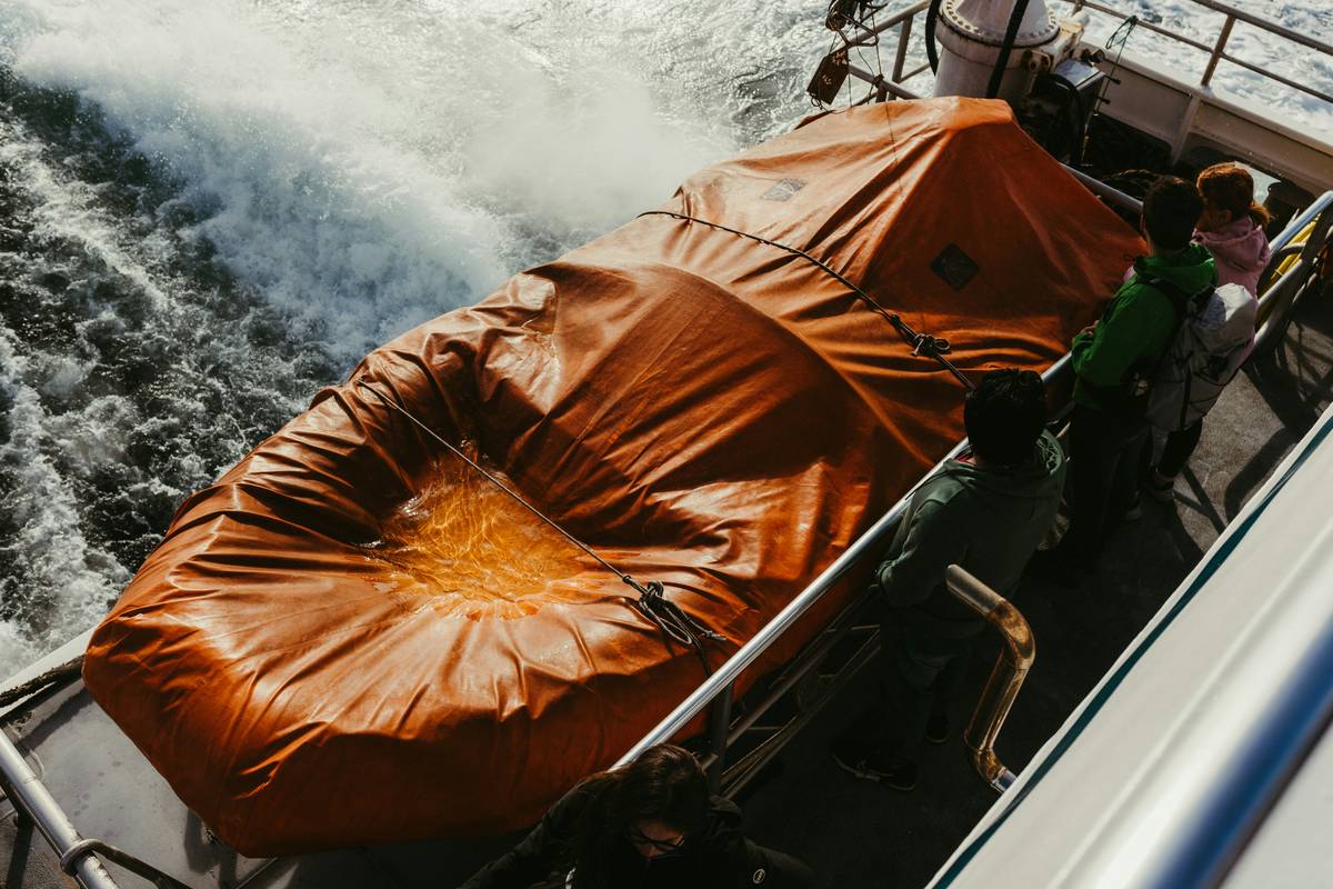 Illustration showing a stranded boat being towed by a rescue vessel